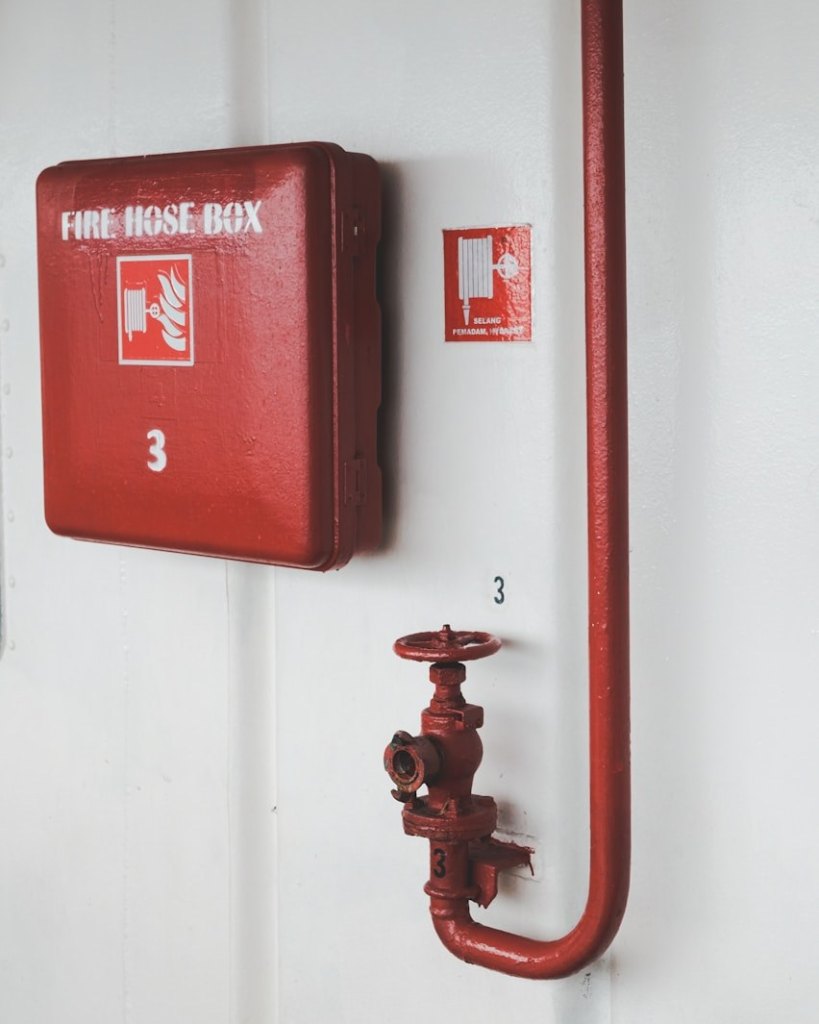 Fire hose cabinet on a factory wall