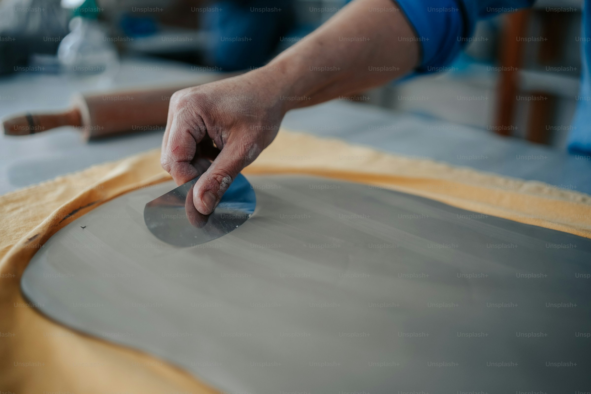 Craftsman smoothing material by hand during production