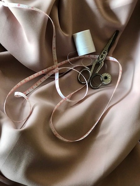 Satin fabric with a measuring tape and scissors