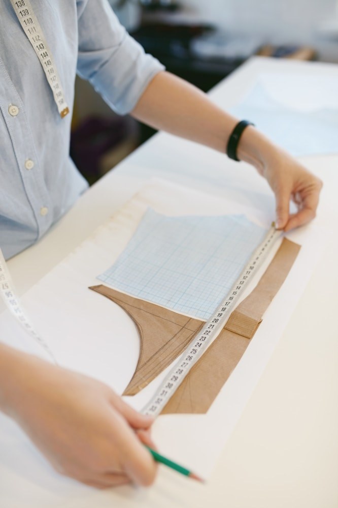Pattern maker marking a garment pattern