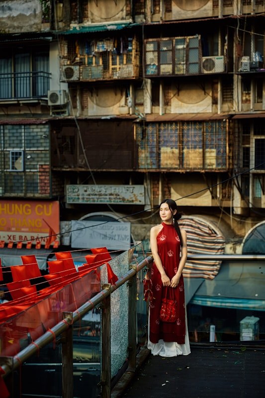 Woman in a red ao dai on a Hanoi street